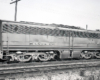 Black-and-white image of the side of a cab-less locomotive.