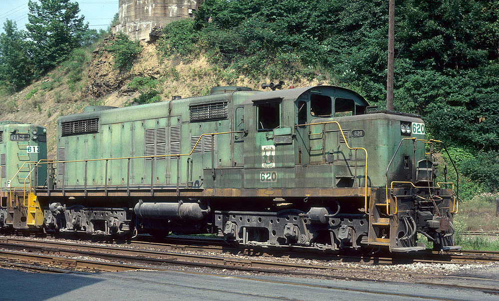 Color image of a green-painted and unusual cab locomotive.