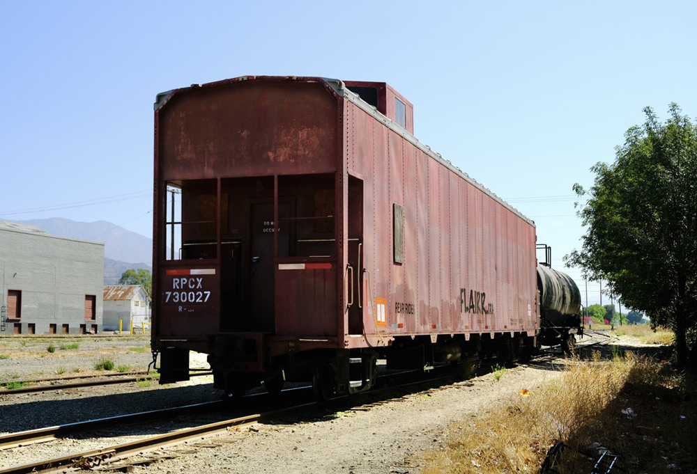 Auto carrier with caboose cupola on siding