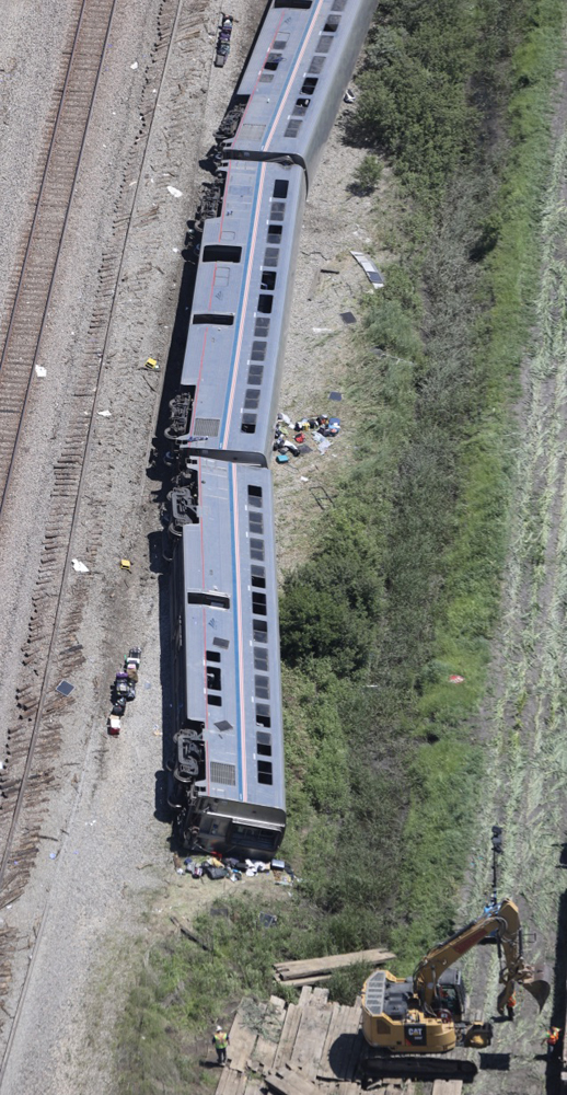 Aerial view of three Superliner passenger cars on their side after derailment