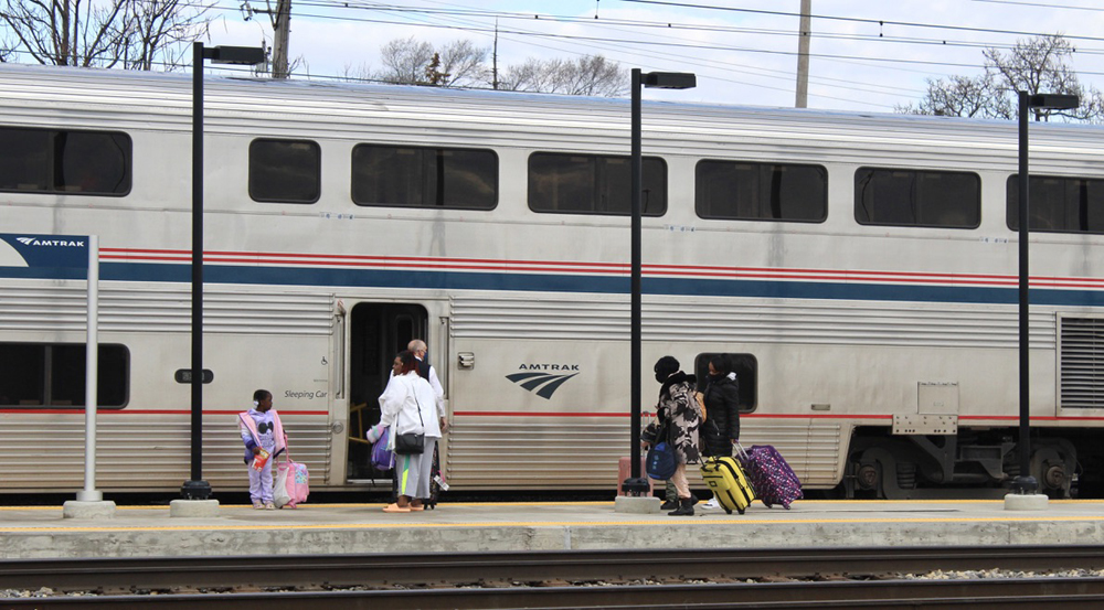 People exiting passenger car at station platform