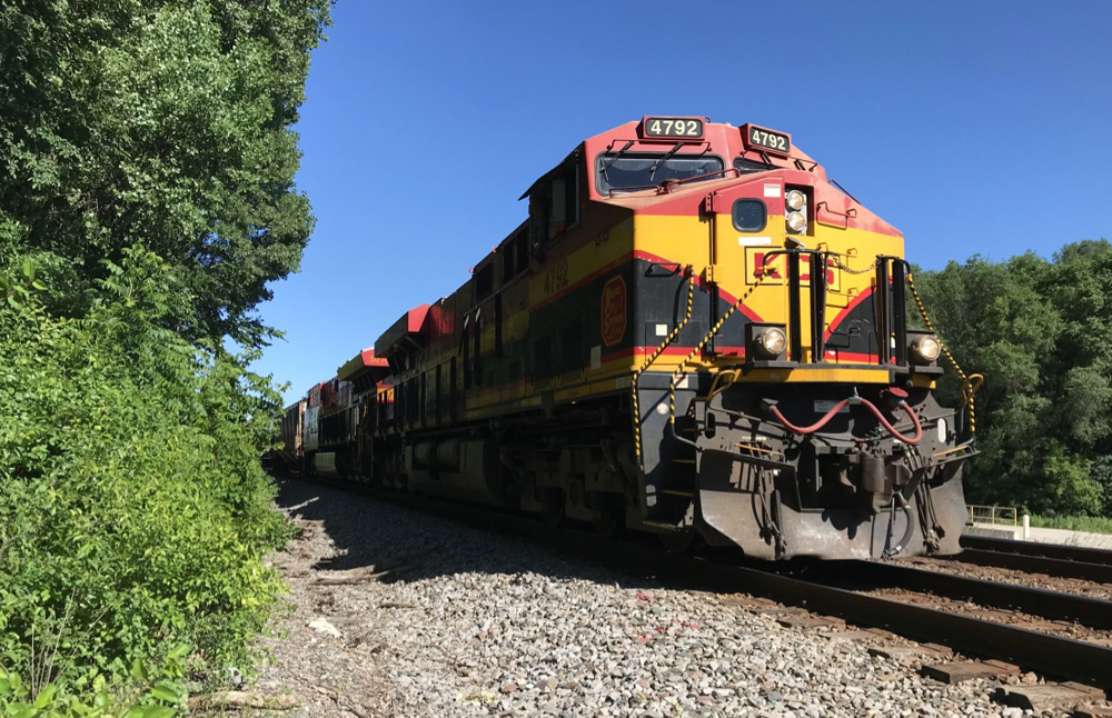 Train with red, yellow, and black locomotives