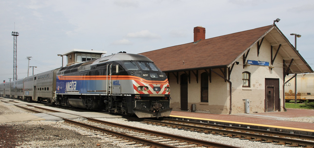 Commuter train at aging brick station