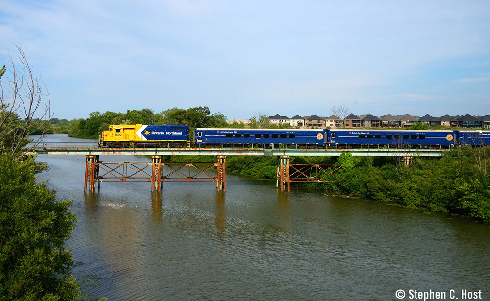Blue and yellow passenger equipment on bridge