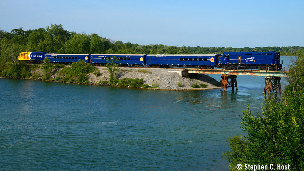 Passenger train on bridge with locomotives at each end