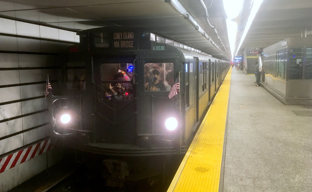 Dark green vintage subway train in station