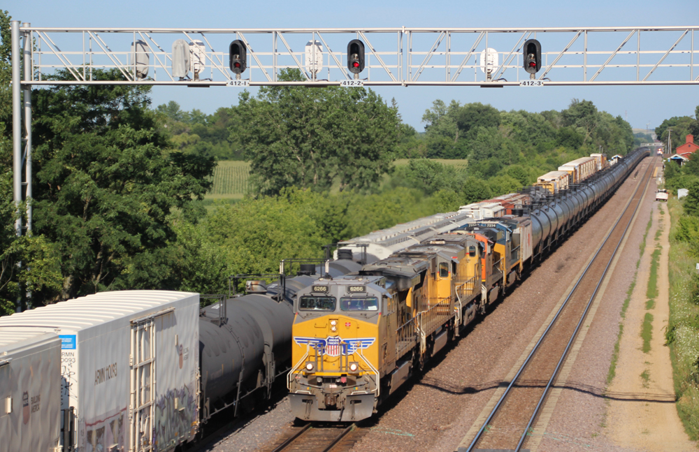 Yellow locomotives on train of tank cars