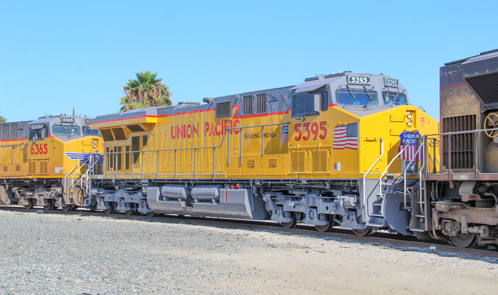 Yellow and gray locomotive with red trim