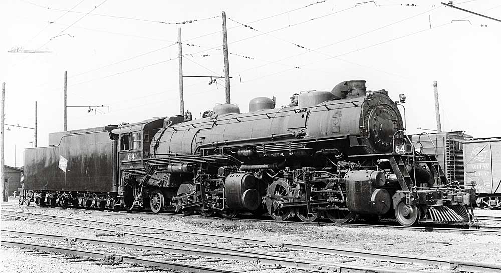Steam locomotive in three-quarter view under wires