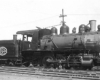 Steam locomotive with slope-back tender in profile