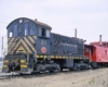 Rear cab diesel locomotive with red caboose