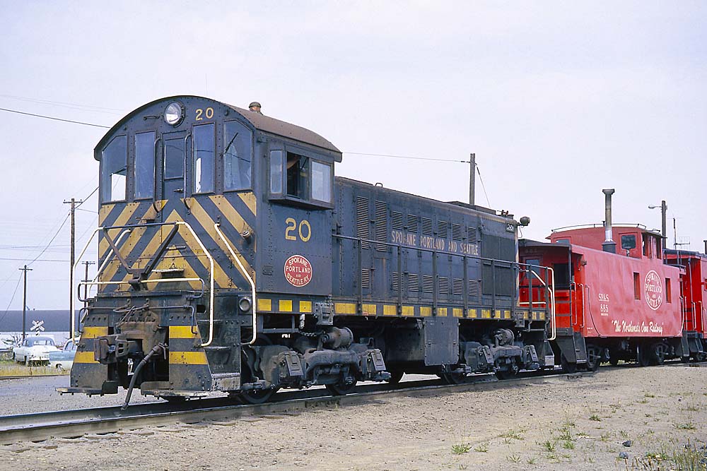 Rear cab diesel locomotive with red caboose