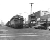 Diesel locomotives with freight train on street in downtown setting