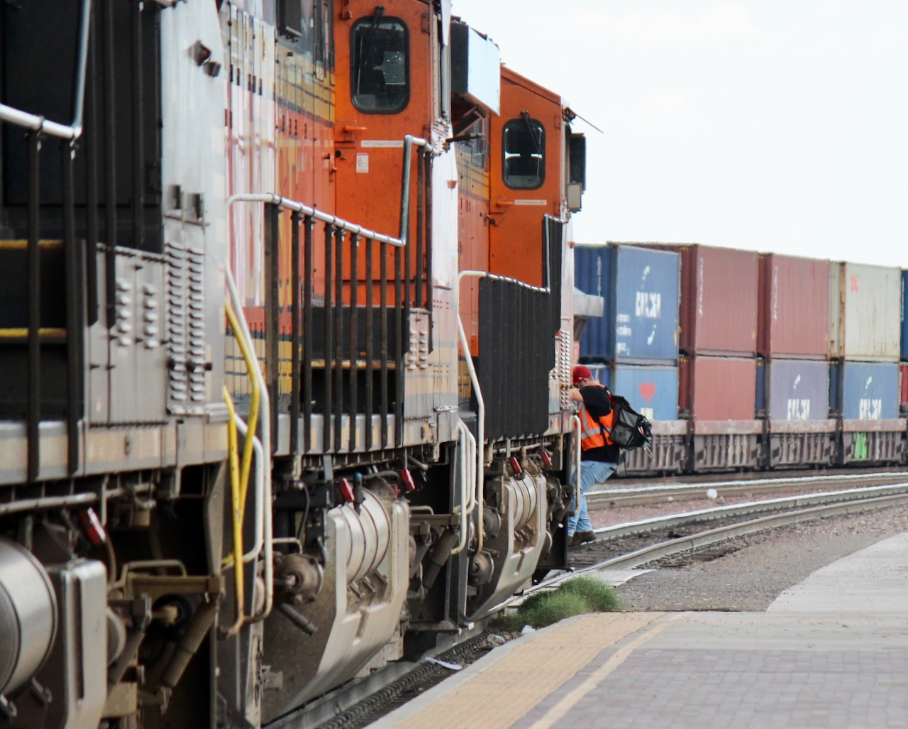 Crew member climbing off locomotive