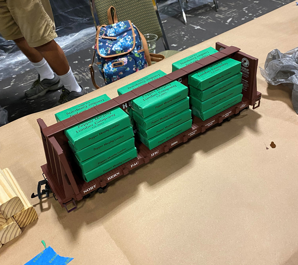 Model flatcar with covered pine log load