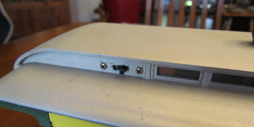 close up of power switch on model passenger car