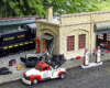 Model gas station with truck and locomotive