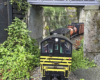 model locomotive travels under bridge