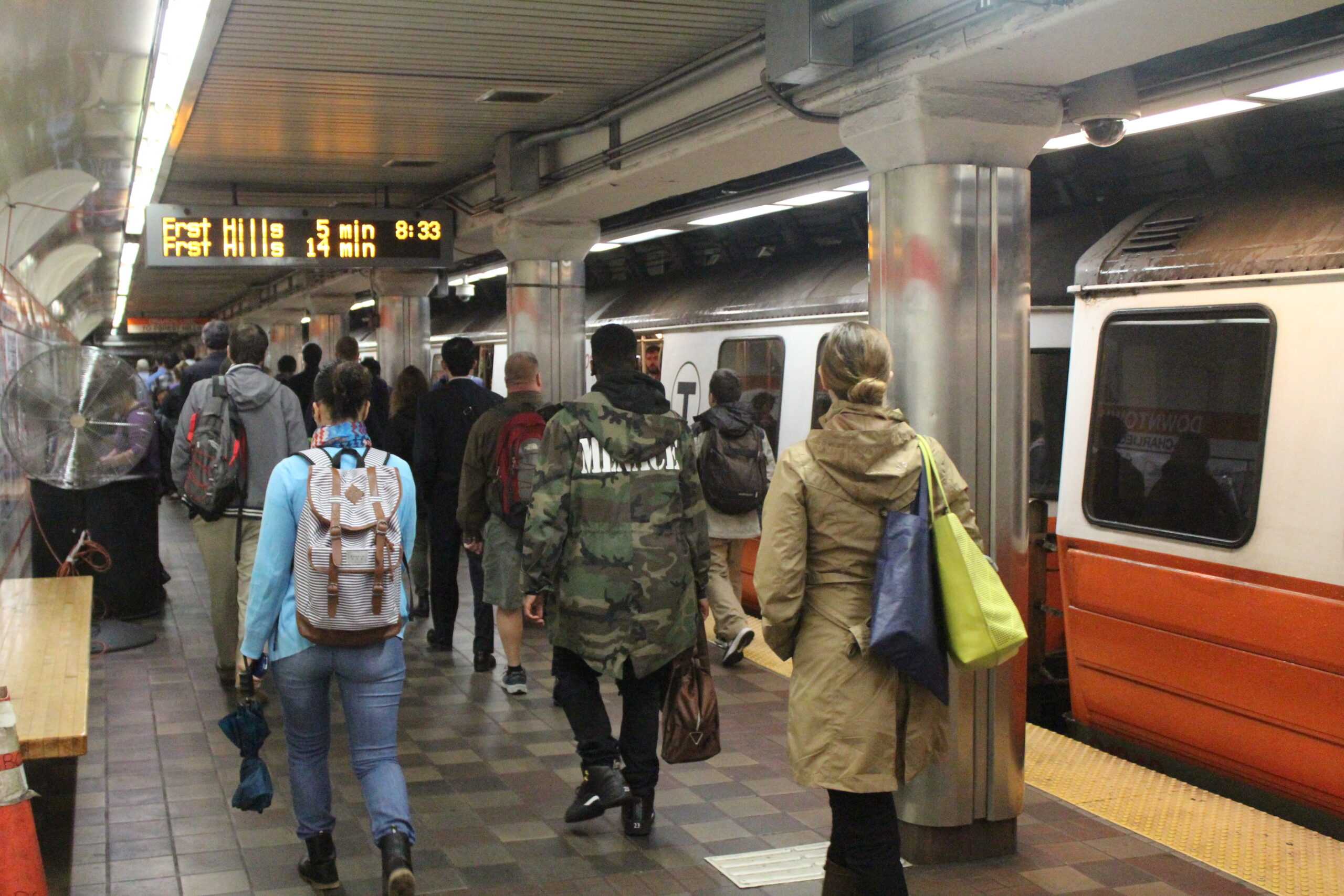 Passengers walking along subway platform