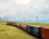 A pair of yellow-and-gray diesels pulls a collection of freight cars through the gently rolling prairie