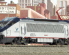 Photo of HO scale modern electric locomotive with city backdrop