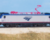 Photo of N scale electric locomotive and passenger cars on scenicked base