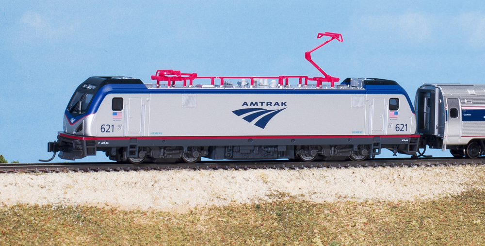 Photo of N scale electric locomotive and passenger cars on scenicked base