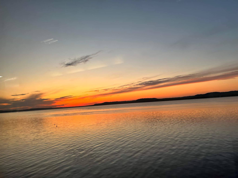 Photo of sunset over large river