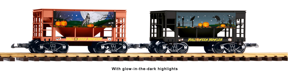 Two ore car models on track with halloween graphics on sides in front of white background