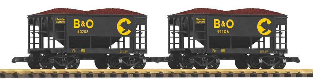 Two black ore cars with Chessie System decoration on track with white background