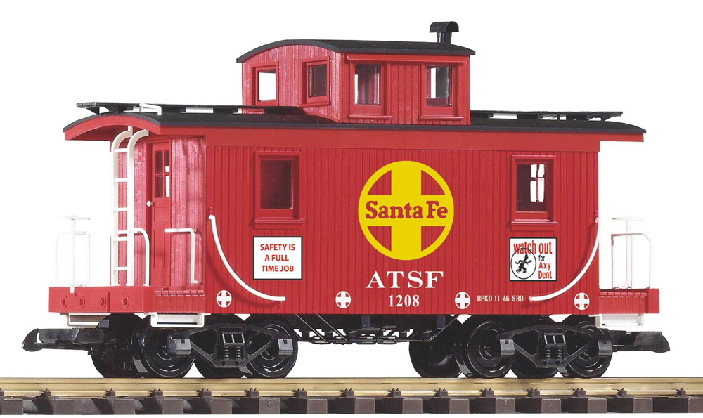 Small red caboose with Santa Fe logo on side in front of white background