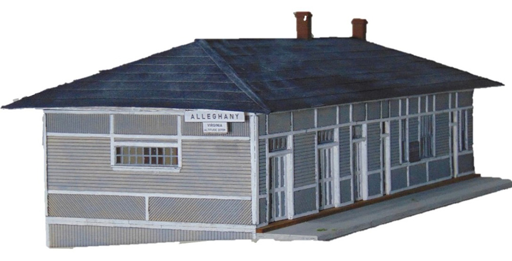Gray station building with black roof and white trim and "Alleghany" sign