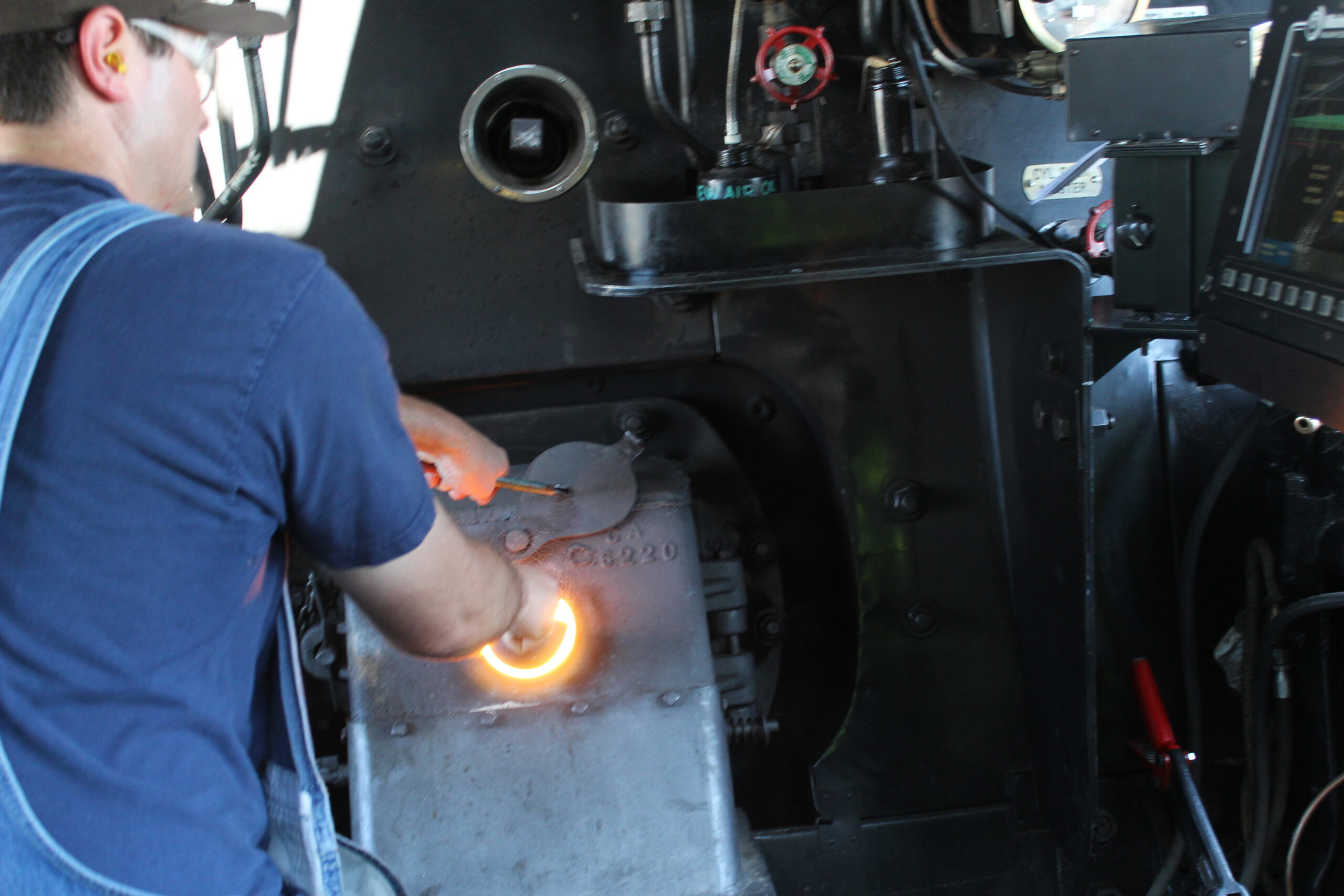 Inside cab of Big Boy steam locomotive. Focused on firebox.