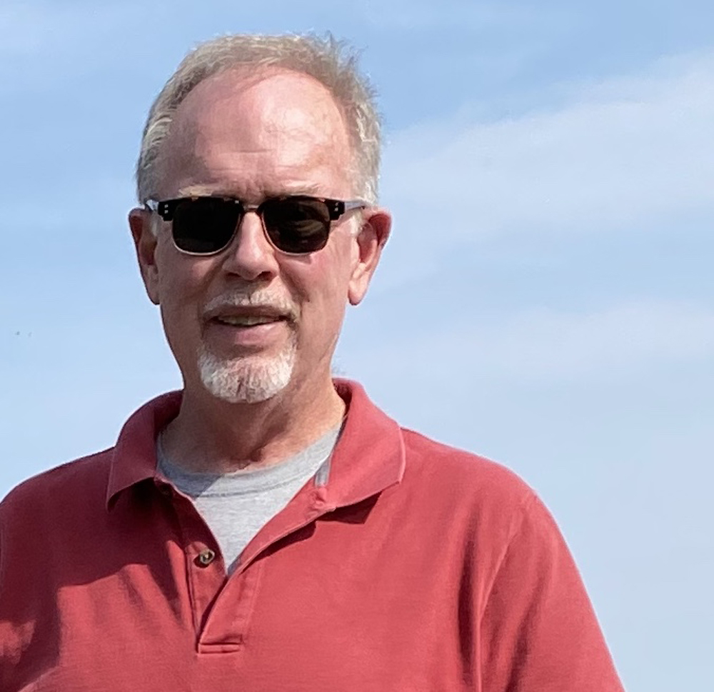 man with glasses and red shirt