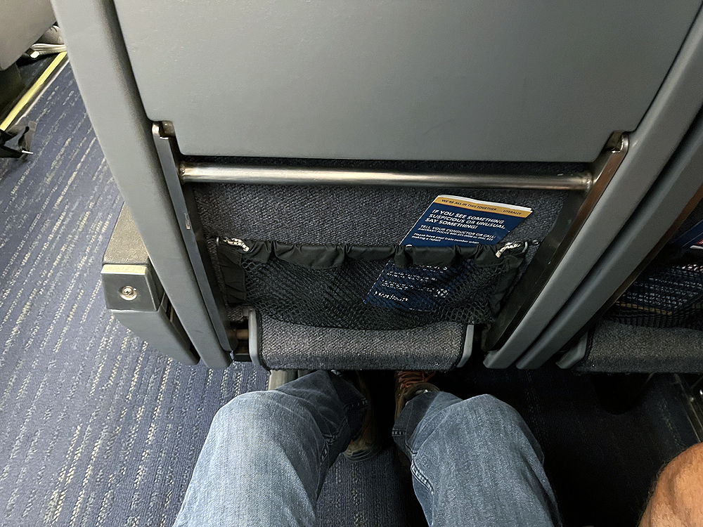 View of space for legs between two seats.