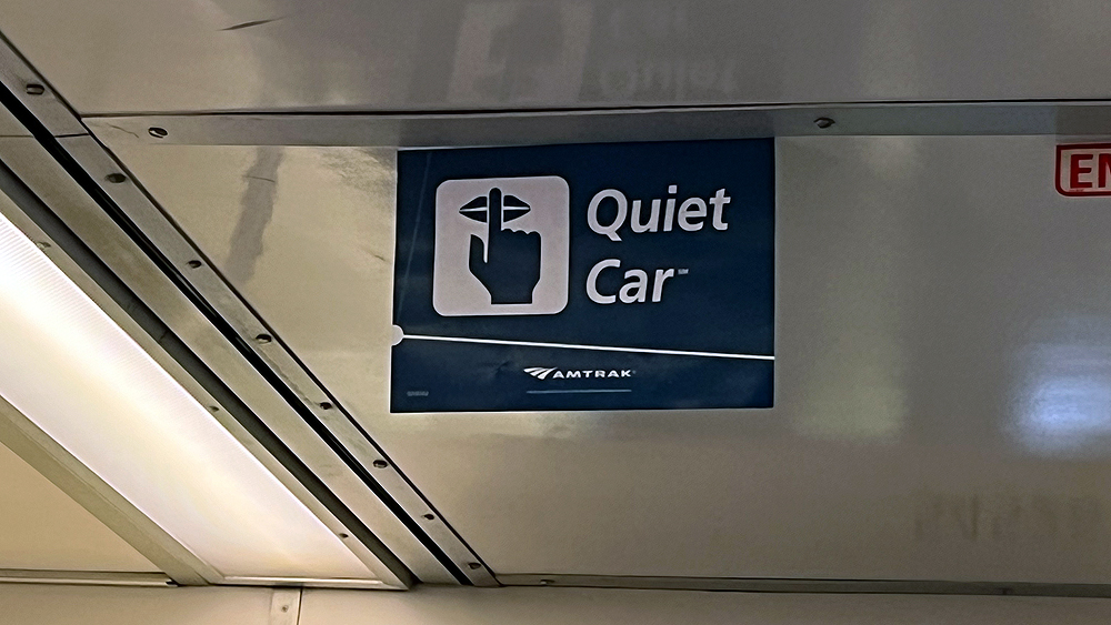 Blue and white sign that reads “Quiet Car”
