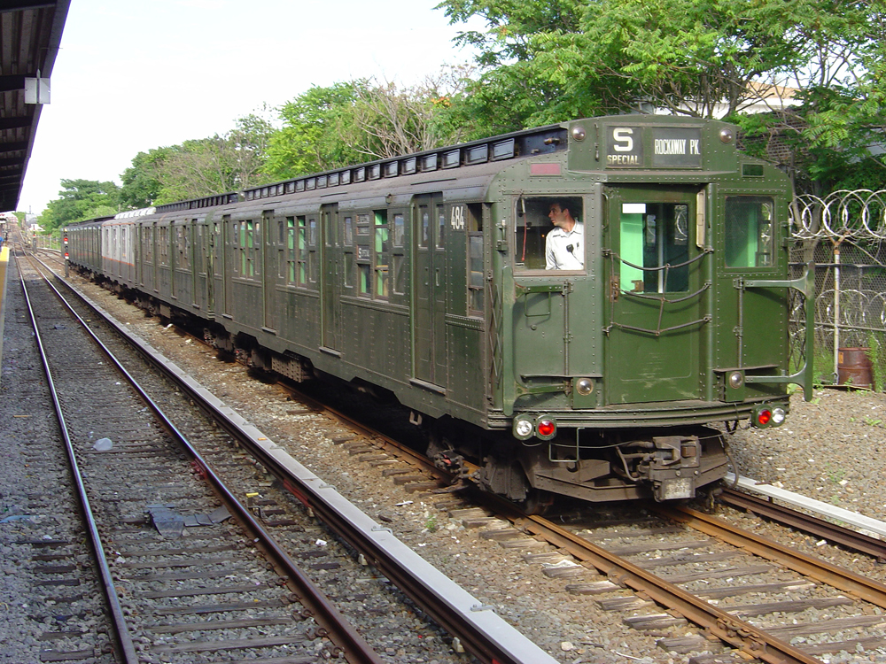 Dark green vintage subway cars at station
