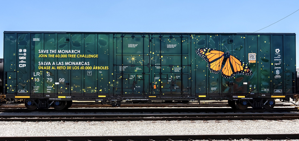 Dark green boxcar with image of monarch butterfly