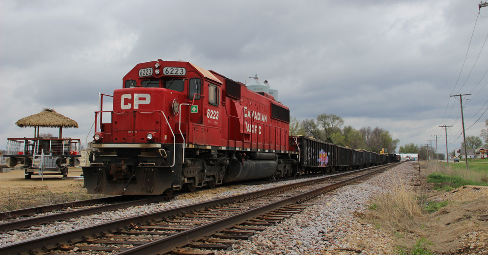 Red locomotive with gondola cars