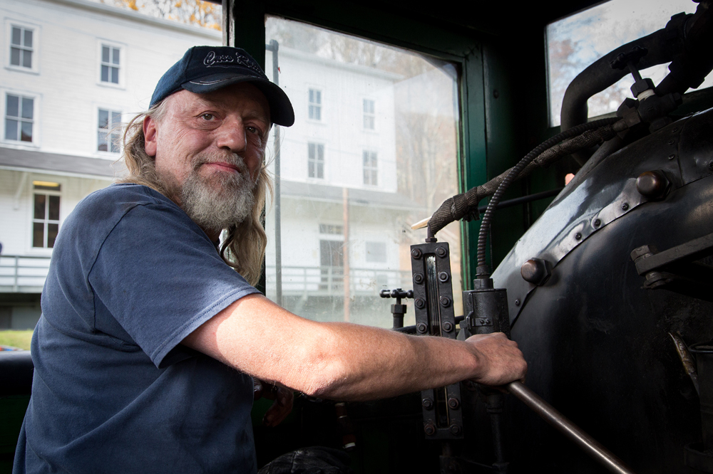 Man at throttle of steam locomotive