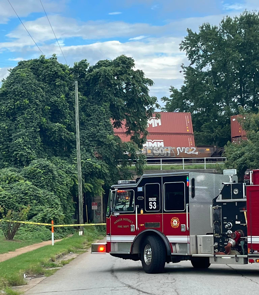 Fire truck on road with railroad car in background