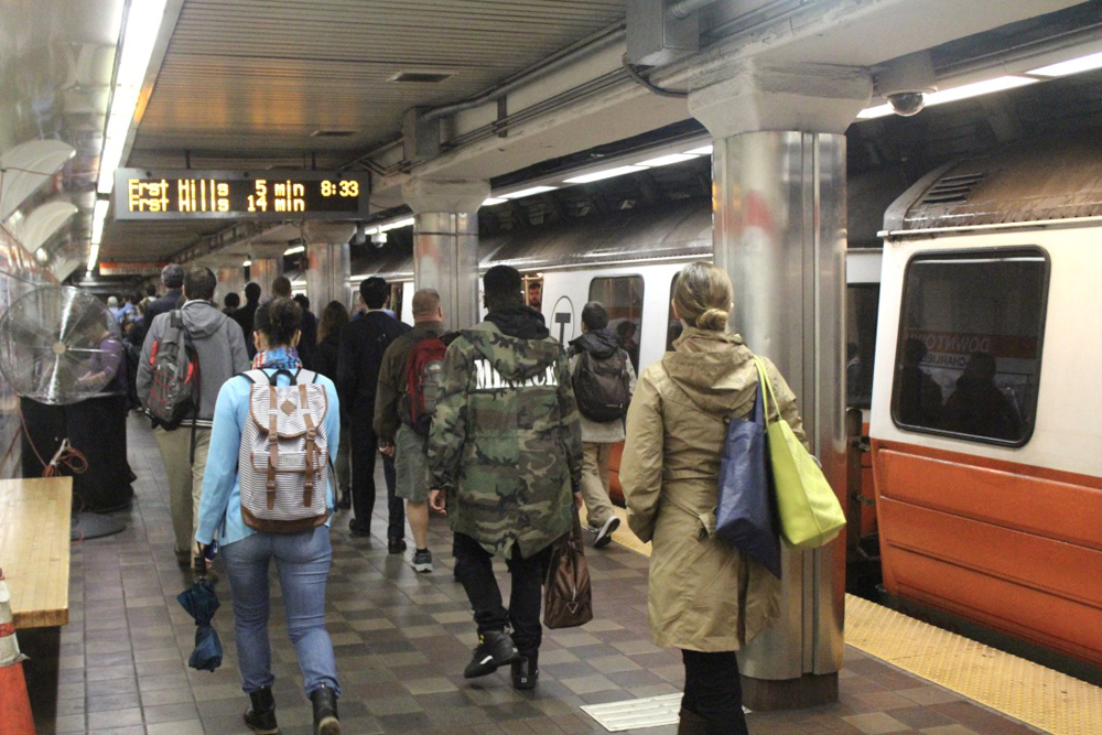 People on station platform next to subway train