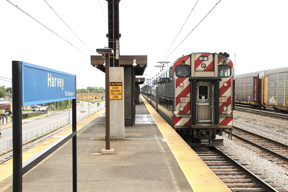 Bilevel commuter train arrives at station platform