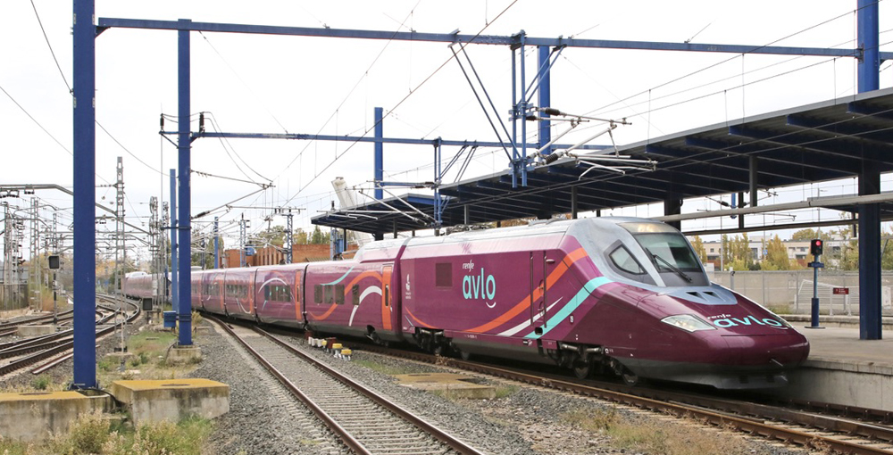 Purple high speed train in station