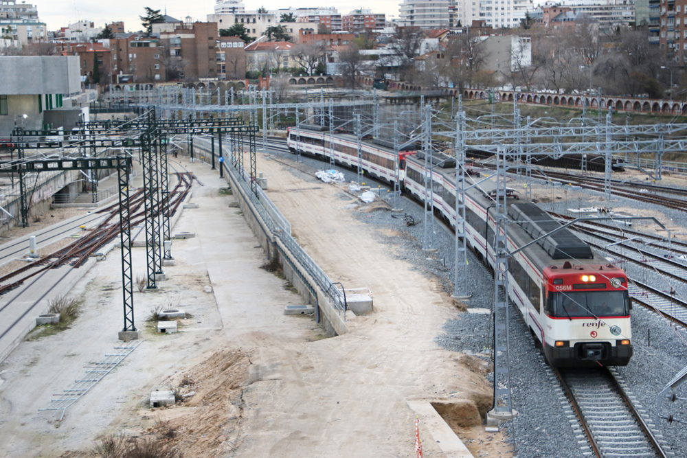 Commuter train rounds curve on freshly ballasted rail line