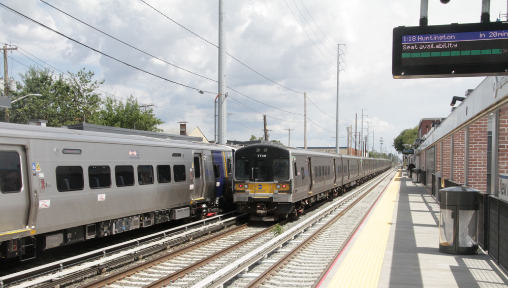 Trains meet on two of three tracks at commuter rail station