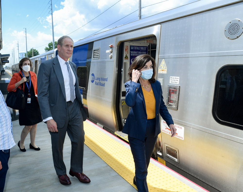 Man and woman on platform at commuter rail station