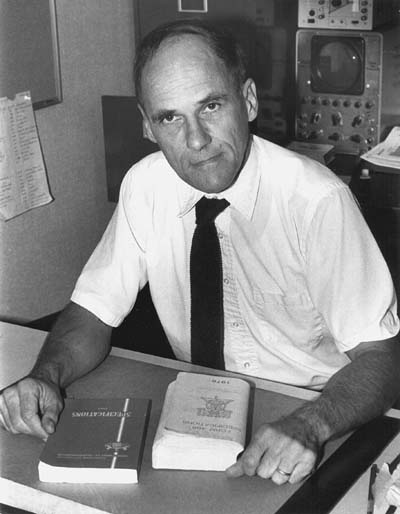 Black and white photo of man in white shirt and tie