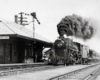 Steam Bangor Aroostook locomotive with train passing wooden station