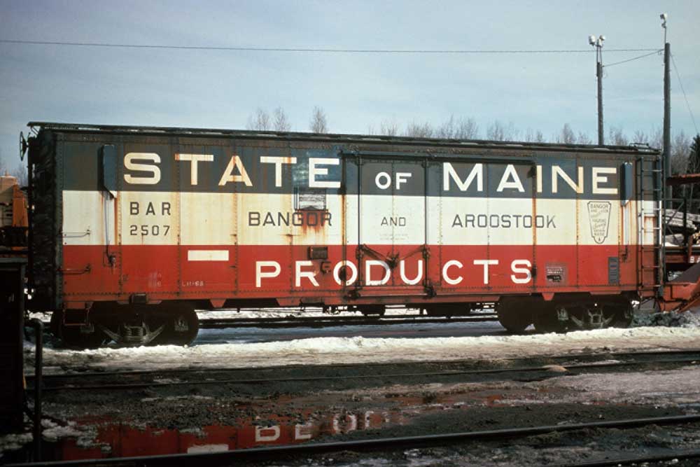 Blue, red, and white Bangor & Aroostook Railroad horizontal striped boxcar